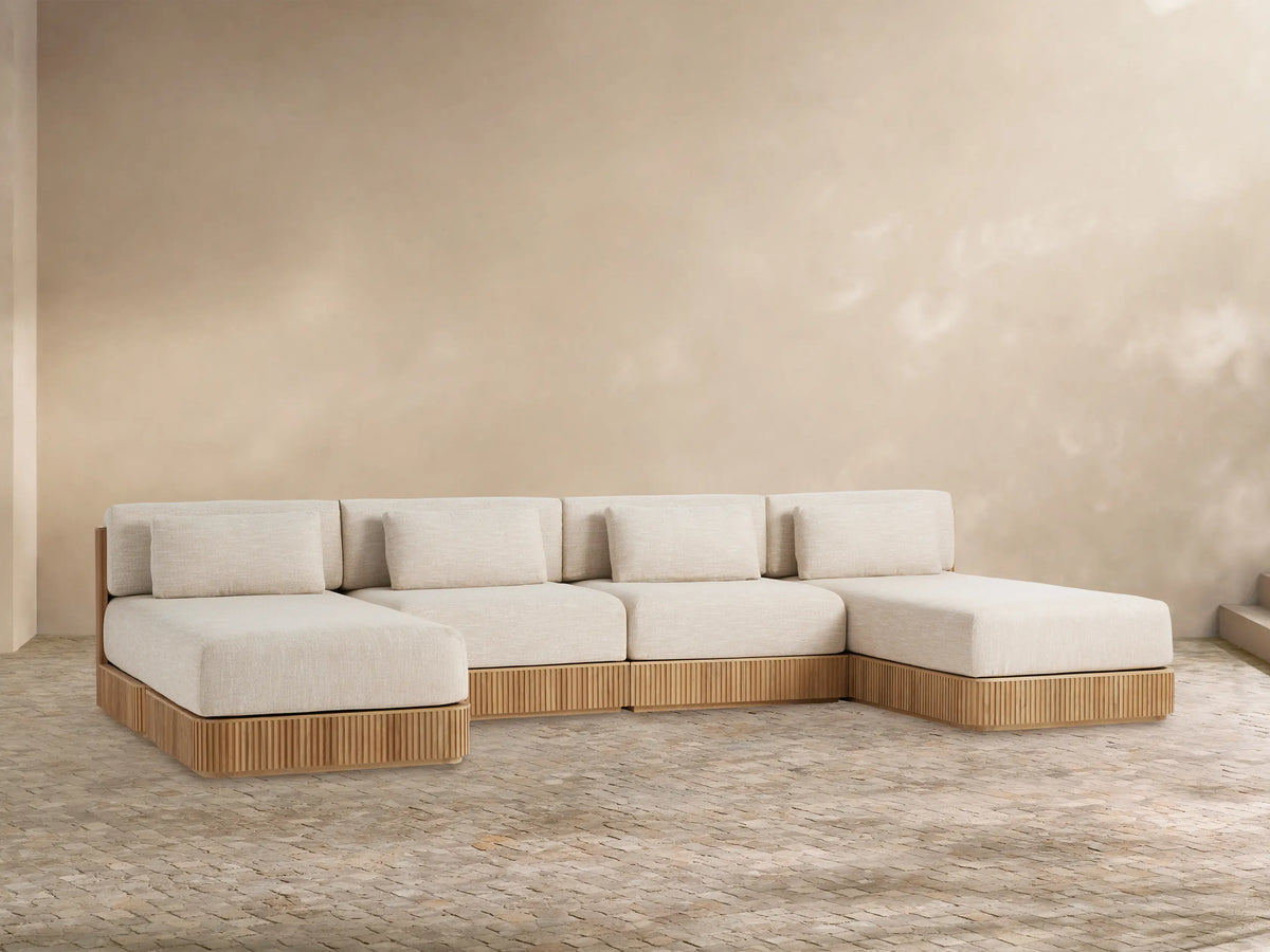 Front view of Beaumont Outdoor Four-Piece Double Chaise Sectional, with light beige cushions and slatted teak wood base.