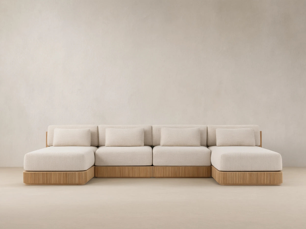Front view of Beaumont Outdoor Four-Piece Double Chaise Sectional, with light beige cushions and slatted teak wood base.