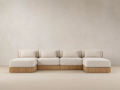 Front view of Beaumont Outdoor Four-Piece Double Chaise Sectional, with light beige cushions and slatted teak wood base.
