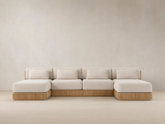 Front view of Beaumont Outdoor Four-Piece Double Chaise Sectional, with light beige cushions and slatted teak wood base.