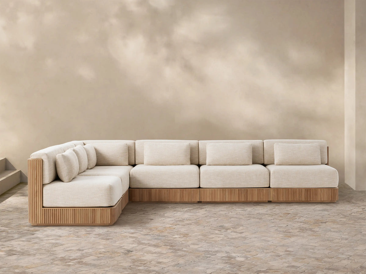 Front view of the Beaumont Outdoor Six-Piece L-Shaped Sectional, featuring a slatted teak wood base and cream cushions.