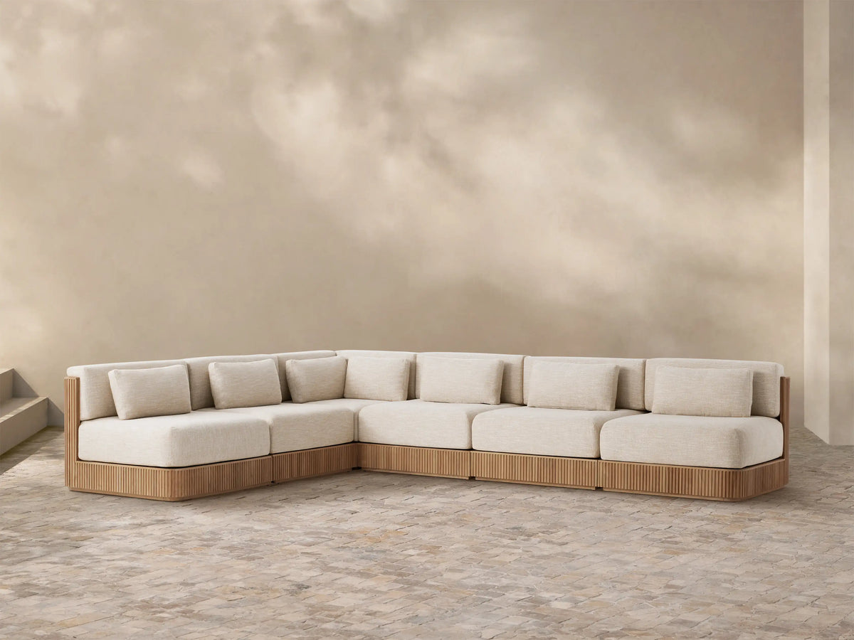 Front view of the Beaumont Outdoor Six-Piece L-Shaped Sectional, featuring a slatted teak wood base and cream cushions.