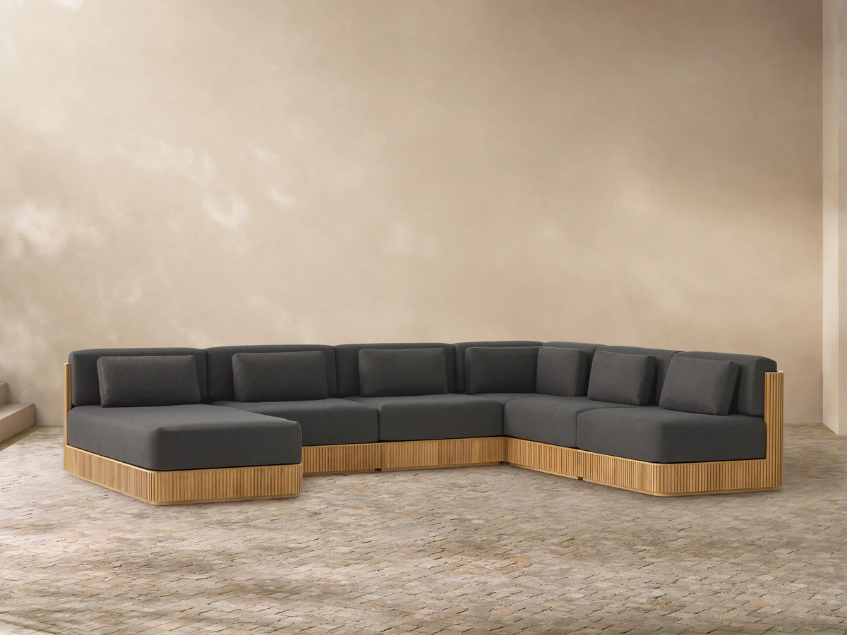 U-shaped Beaumont Outdoor Teak Six-Piece Sectional with chaise, dark grey cushions, and slatted natural teak base.