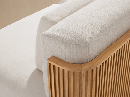 Beaumont Outdoor Teak Two-Piece Modular Sofa with cream cushions and a natural teak wood slatted base, against a beige wall.