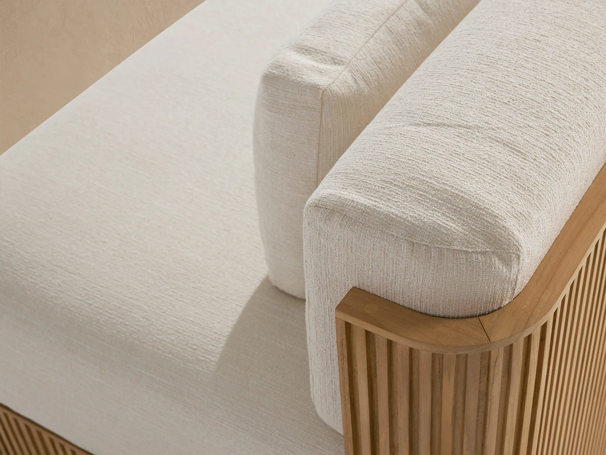 Beaumont Outdoor Teak 3-Piece Modular Sofa with natural teak slatted base & cream cushions, angled on a paved patio.