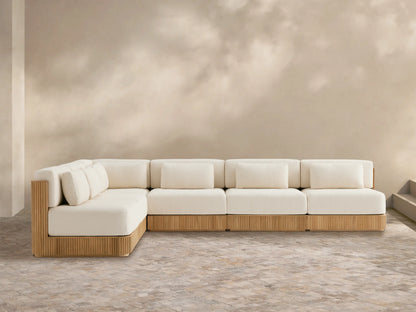 L-shaped Beaumont Outdoor Teak Six-Piece Sectional with grooved teak base & cream cushions on a tiled patio.