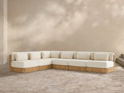L-shaped Beaumont Outdoor Teak Six-Piece Sectional with grooved teak base & cream cushions on a tiled patio.