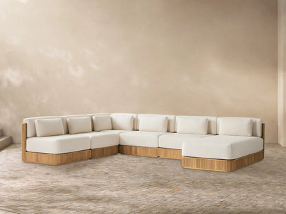 Front view of the Beaumont Outdoor Teak Six-Piece Sectional with Chaise, showing cream cushions and slatted teak base.