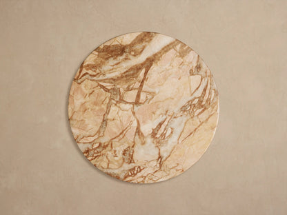 Close-up of Fira Outdoor End Table's round top, showing light beige surface with prominent reddish-brown marble-like veining.