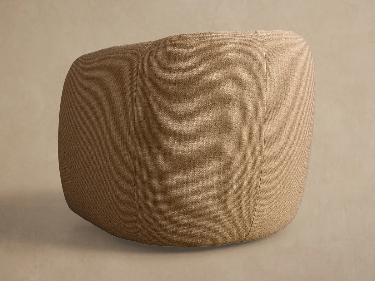 Close-up of the tan textured fabric on the curved seat and backrest of the Fresno Outdoor Swivel Chair.