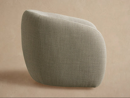 Fresno Outdoor Swivel Chair, back view. Rounded chair in speckled grey-green fabric, angled left, on a textured beige surface.