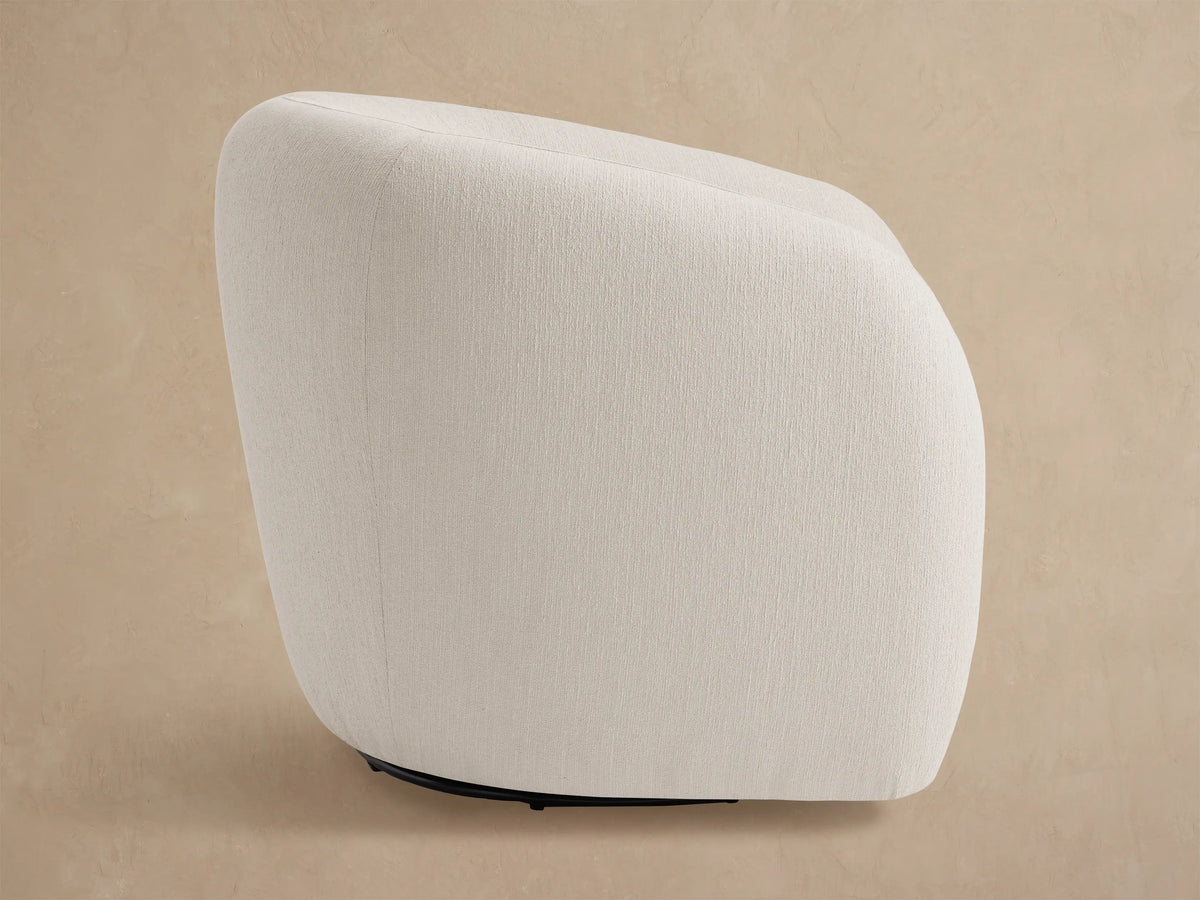 Fresno Outdoor Swivel Chair. Front view of a plush, rounded off-white chair with a black swivel base.