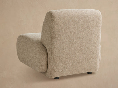 Front view of a modern Gianni Outdoor Lounge Chair in light beige textured fabric with rounded cushions, on a tiled floor.