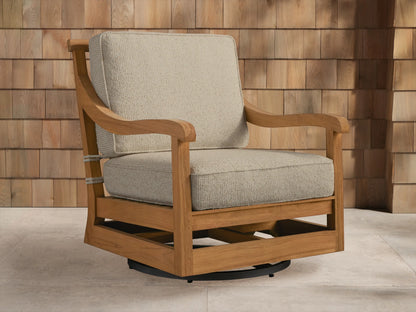 Hamptons Outdoor Swivel Chair in weathered fawn teak with light beige cushions, angled on an outdoor patio setting.