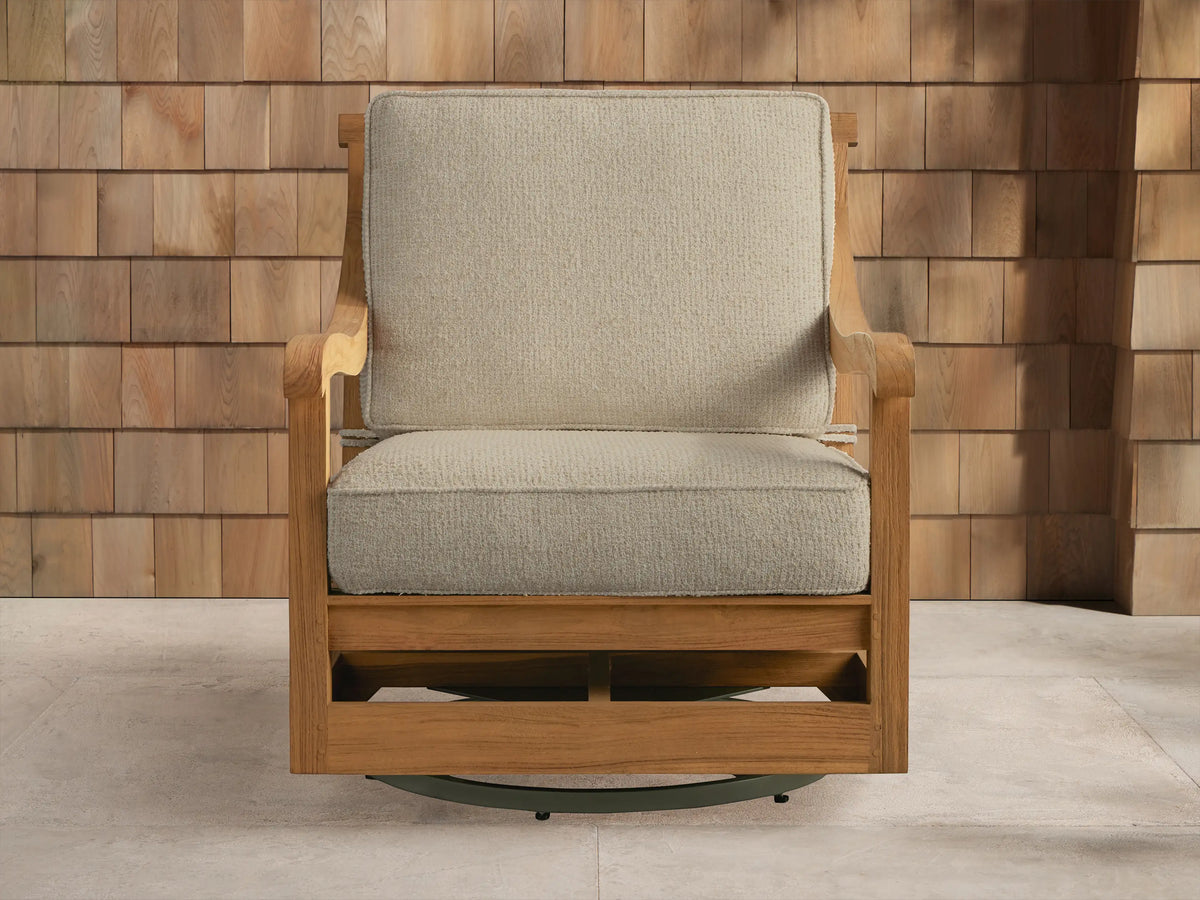 Hamptons Outdoor Swivel Chair in weathered fawn teak with light beige cushions, angled on an outdoor patio setting.