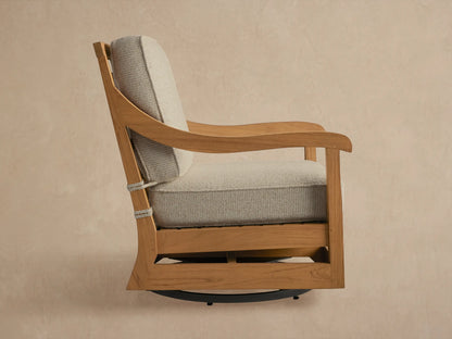 Hamptons Outdoor Swivel Chair in weathered fawn teak, light grey cushions, angled back view with decorative geometric pattern.