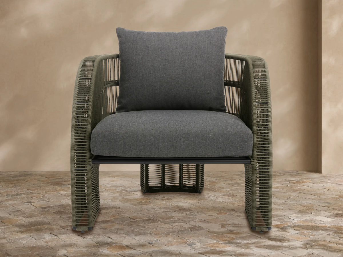 Light grey Ibiza Outdoor Collection cover on a chair, textured fabric with a front seam, in an outdoor patio setting.