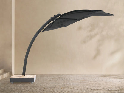 Black Icarus outdoor umbrella, open and tilted to the right, with a curved dark gray pole and a light wood-slatted base on wheels.
