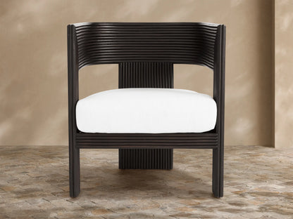 White Ilia Outdoor Water-Repellent Replacement Cushion in dark brown ribbed chair, front view, on tiled floor.
