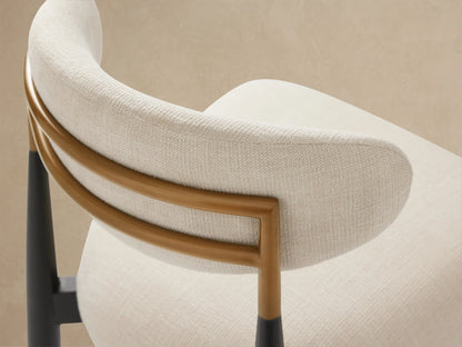 Jagger Outdoor Dining Side Chair with sleek black teak frame, off-white upholstered seat & back, subtle brass accent, centered.