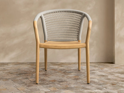 Light gray textured Kaia Outdoor Collection Cover, front view, with a V-seam and vertical slit, on a stone-tiled floor.