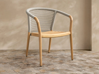 Front view of the Kaia Outdoor Dining Chair with Cushion, featuring a natural teak wood frame and light gray woven back.