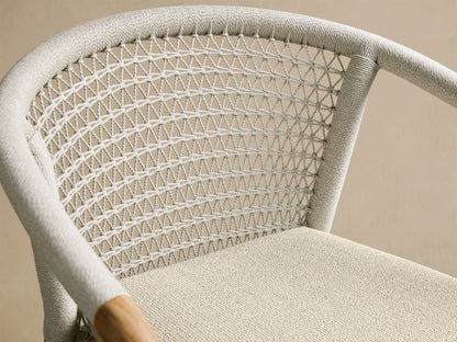 Close-up of the Kaia Outdoor Dining Chair with Cushion, showing the light gray Performance Weave rope backrest and beige cushion.