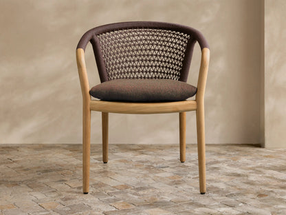 Front view of the Kaia Outdoor Dining Chair with Cushion, showcasing a natural teak frame, dark brown woven back, and reddish-brown cushion.
