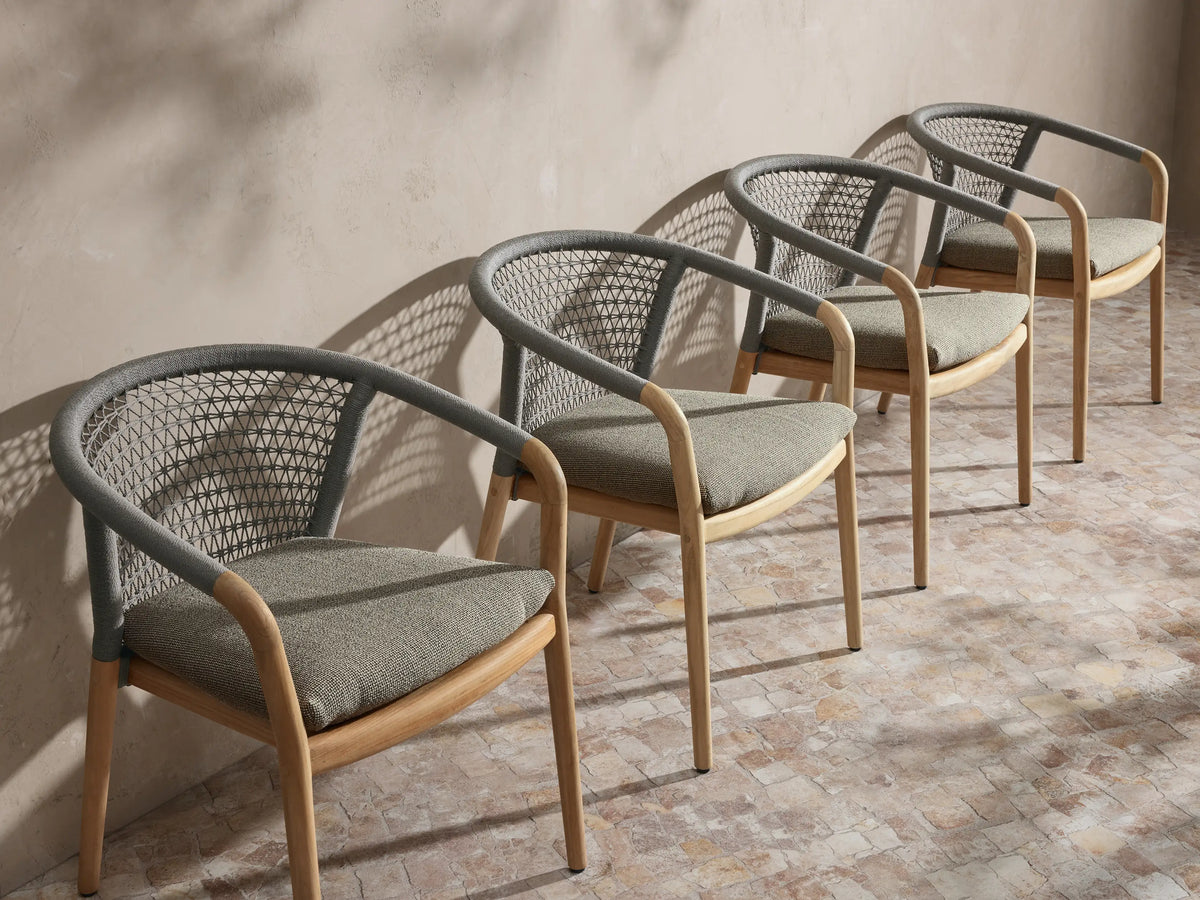Front view of the Kaia Outdoor Dining Chair with Cushion featuring a natural teak frame, gray woven back, and light gray cushion.