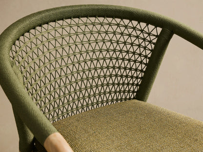 Close-up of the olive green handwoven rope back and moss green textured cushion of the Kaia Outdoor Dining Chair with Cushion.