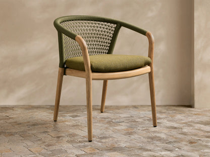 Stacked view of two natural teak Kaia Outdoor Dining Chairs with Cushion, featuring dark green woven rope backs.