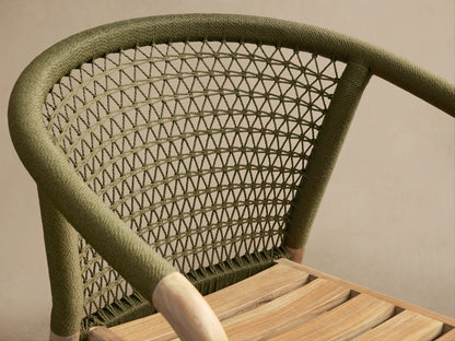 Close-up of the olive green woven back and natural teak slatted seat of the Kaia Outdoor Dining Chair with Cushion.