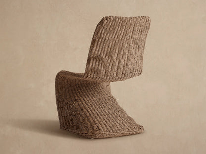 Close-up of a Leon Outdoor Dining Chair, showing its natural light beige handwoven all-weather resin wicker seat and back.