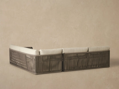 Lisbon Outdoor Two-Piece Sectional, light beige cushions & lumbar pillows, dark brown woven rope armrest, close-up.