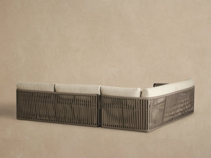 Lisbon Outdoor Two-Piece Sectional, close-up. Light beige textured cushions and armrest with vertical woven taupe rope.