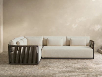 Lisbon Outdoor Two-Piece Sectional, L-shaped, with light beige cushions and dark brown vertical woven rope frame on a patio.