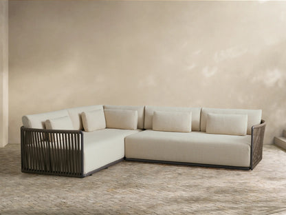 Lisbon Outdoor Two-Piece Sectional with natural cushions and dark brown woven frames, accented with pillows.