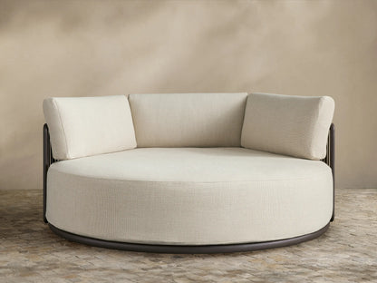 Lisbon Outdoor Daybed: round, cream performance fabric seat & three back cushions on a dark aluminum frame.