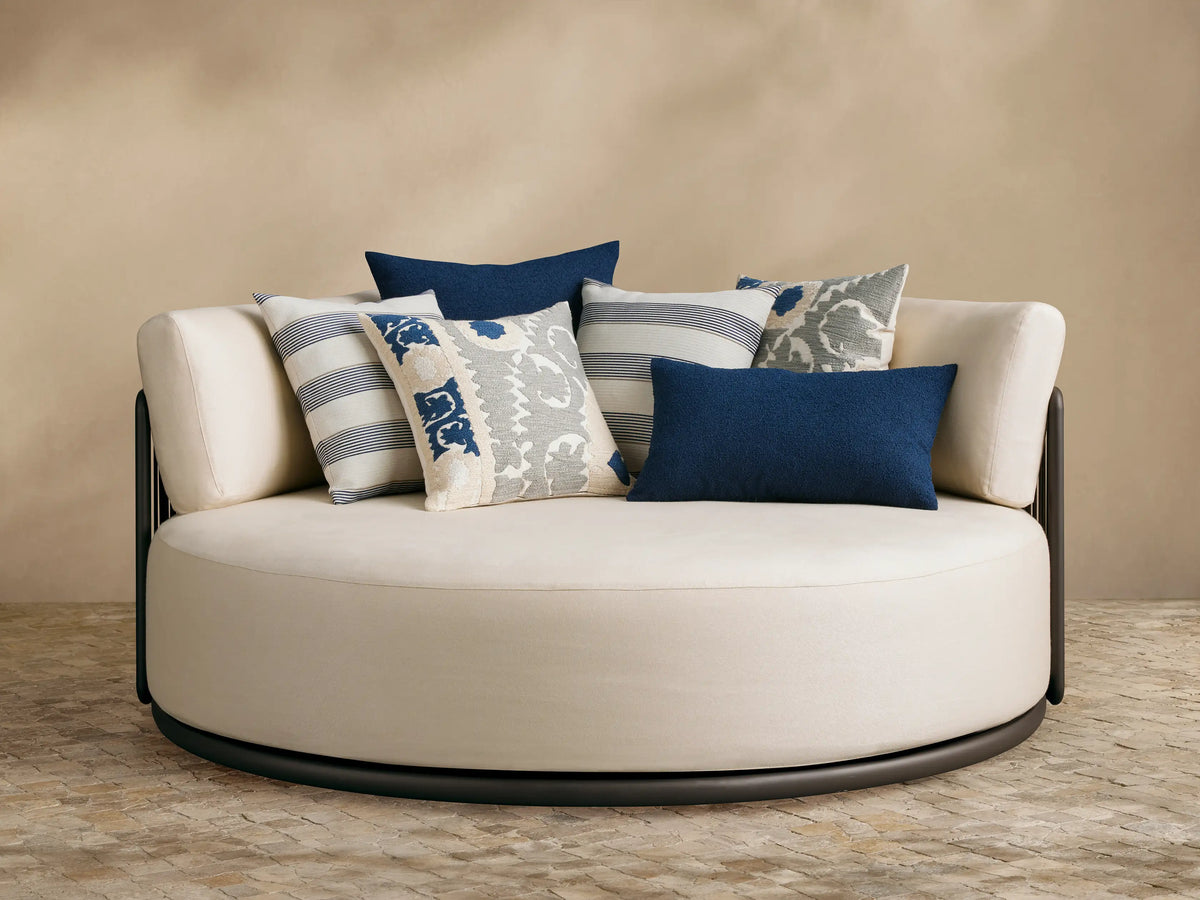 Lisbon Outdoor Daybed, curved back with dark brown rope-wrapped frame and light beige cushions, viewed from the side.