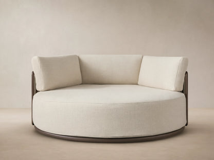 Lisbon Outdoor Daybed: round, cream performance fabric seat & three back cushions on a dark aluminum frame.