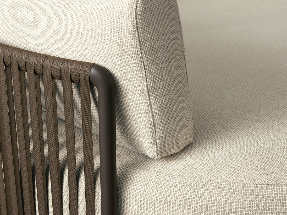 Round Lisbon Outdoor Daybed, cream fabric with dark frame, featuring solid navy, striped, and patterned blue/beige pillows.