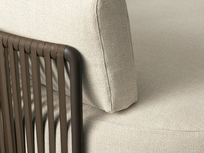 Round Lisbon Outdoor Daybed, cream fabric with dark frame, featuring solid navy, striped, and patterned blue/beige pillows.