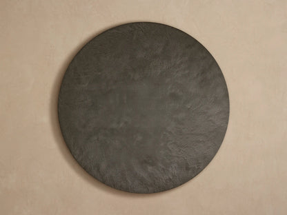 Close-up, angled view of Pompeii Outdoor Round Coffee Table with dark gray concrete top and vertically slatted teak wood base.