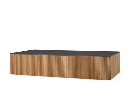 Pompeii Outdoor Coffee Table with a rectangular black concrete top and vertically grooved natural teak wood sides.