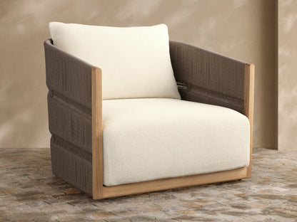 Manadala Outdoor Swivel Chair with natural teak frame, dark brown woven rope arms/back, ivory cushions, on patio tiles.