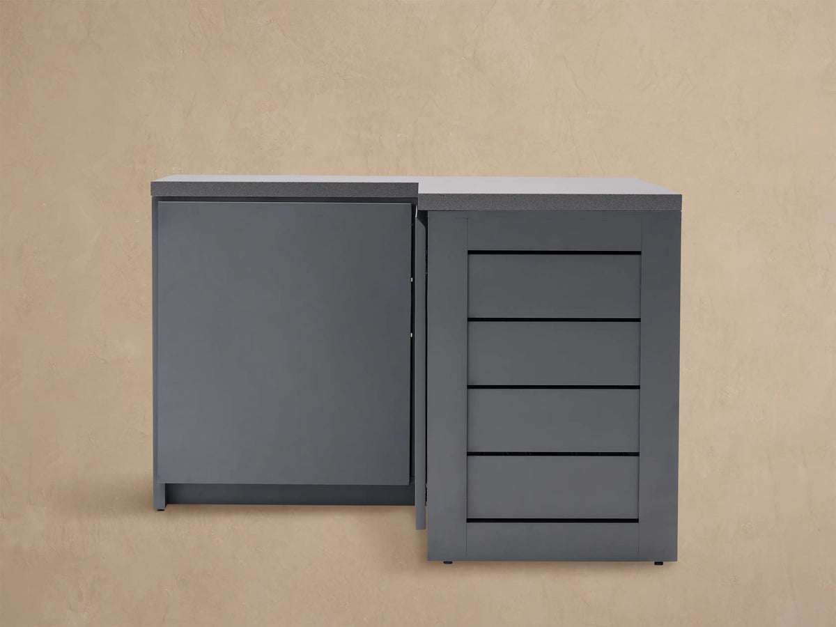 Dark gray L-shaped outdoor aluminum modular kitchen corner cabinet with light gray sintered stone top and grooved side panels.