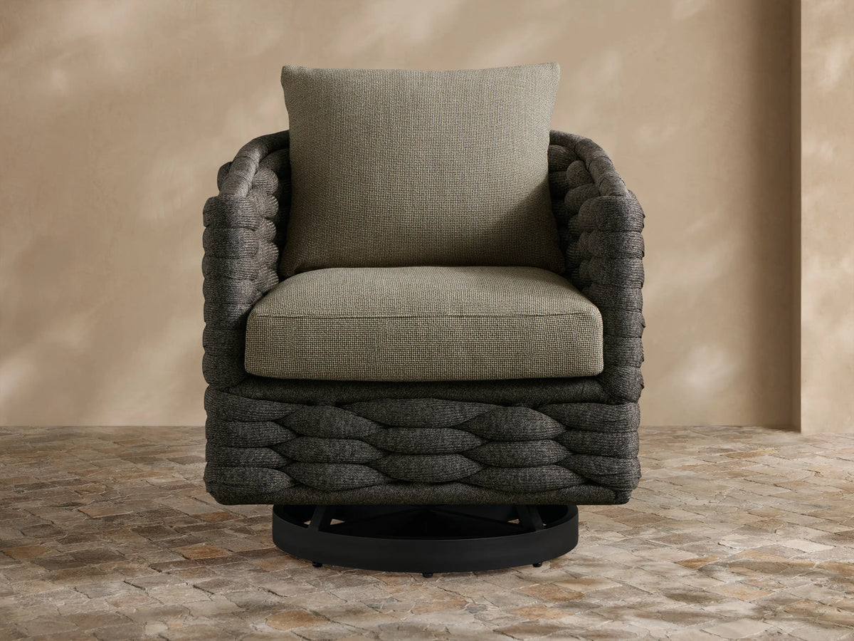 Front view of light grey Melbourne Outdoor Collection Cover on a chair, featuring textured fabric & lower seam, on a patio.