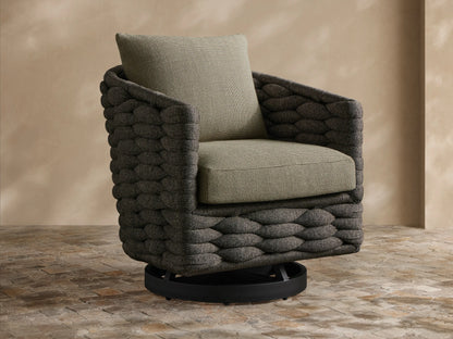 Melbourne Outdoor Swivel Chair: dark charcoal woven body, light olive-gray cushions. Slight angle, on a stone patio.