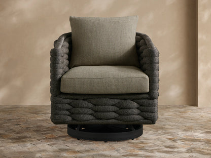 Melbourne Outdoor Swivel Chair: dark charcoal woven body, light olive-gray cushions. Slight angle, on a stone patio.