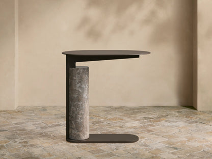 Light gray Minori Outdoor Collection Cover on a patio. It's tailored, rectangular with a rounded top, features a front flap.